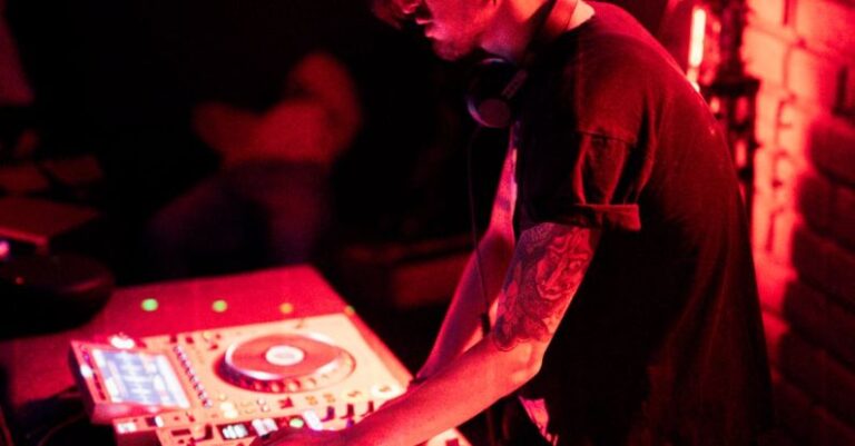 Turntables - Young Brunette Working with Mixer in Nightclub