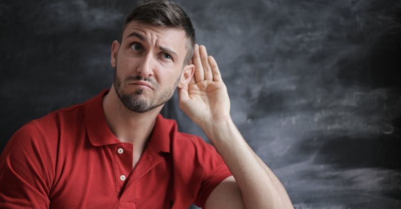 Listening - Man in Red Polo Shirt Sitting Near Chalkboard