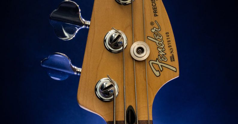 Bass - Close-Up Photography of Brown Fender Guitar Headstock