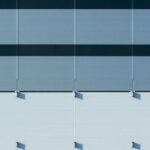 Panels - A close up of a building with blue and white stripes