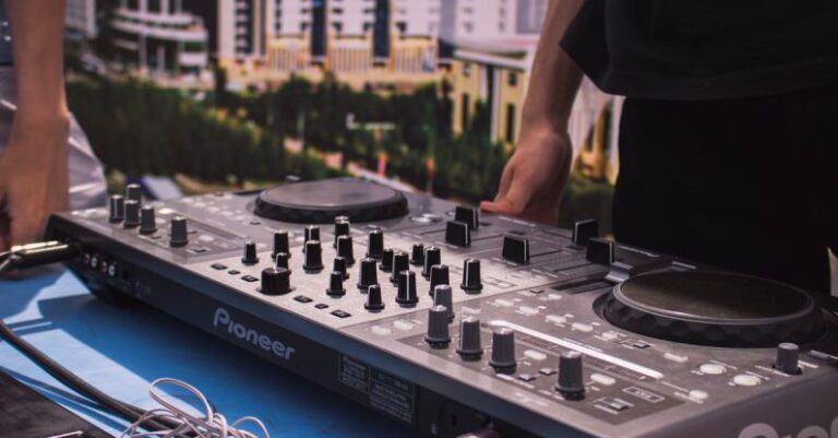 Turntables - Person in Black T-shirt Standing in Front of Black Dj Mixer