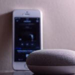 Speakers - Gray Google Home Mini Beside Silver Iphone 5s