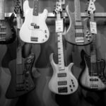 Acoustics - 8 Electric Guitars Hanged on Brown Steel Bar